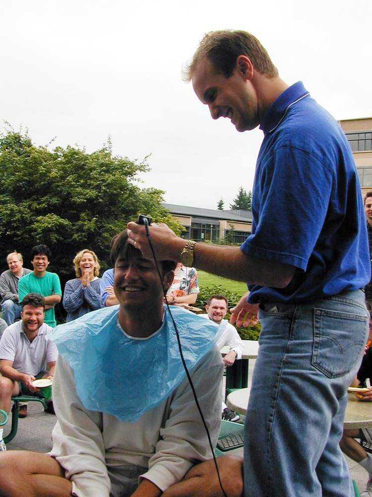 Rich Barton receiving a haircut after Expedia team members beat a deadline in 1999
