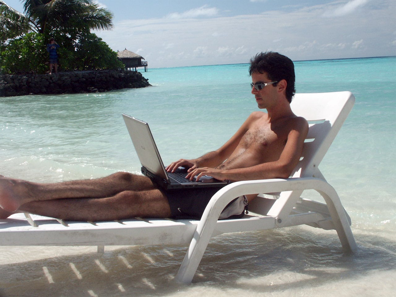 A tourist checks email while on vacation in the Maldives.