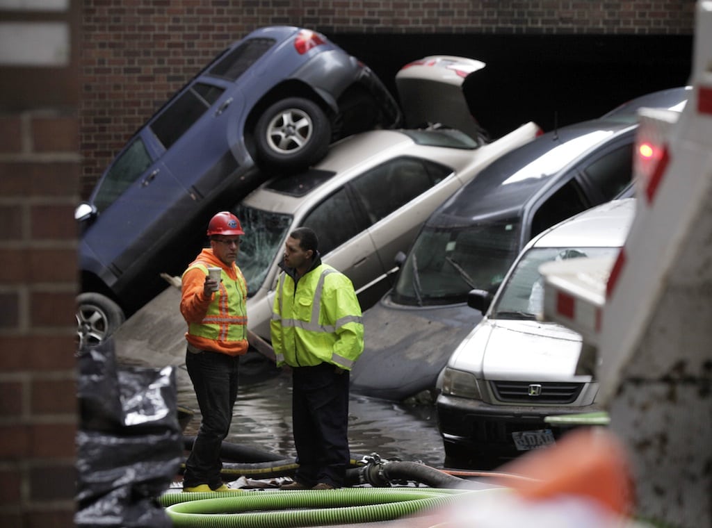 In this Friday, Nov. 2, 2012, file photo, cars that were uprighted and submerged by Superstorm Sandy remain at the entrance of a subterranean parking garage in New York's Financial District, as the water is pumped out. 