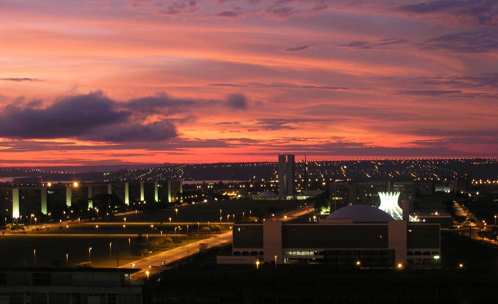 The sun sets in Brasilia outside a hotel window. 
