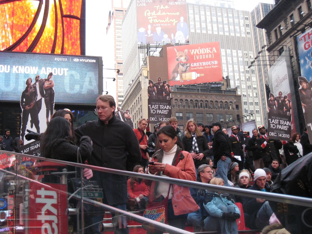 Tourists gather near the tkts booth in Times Square to get discounted Broadway tickets.