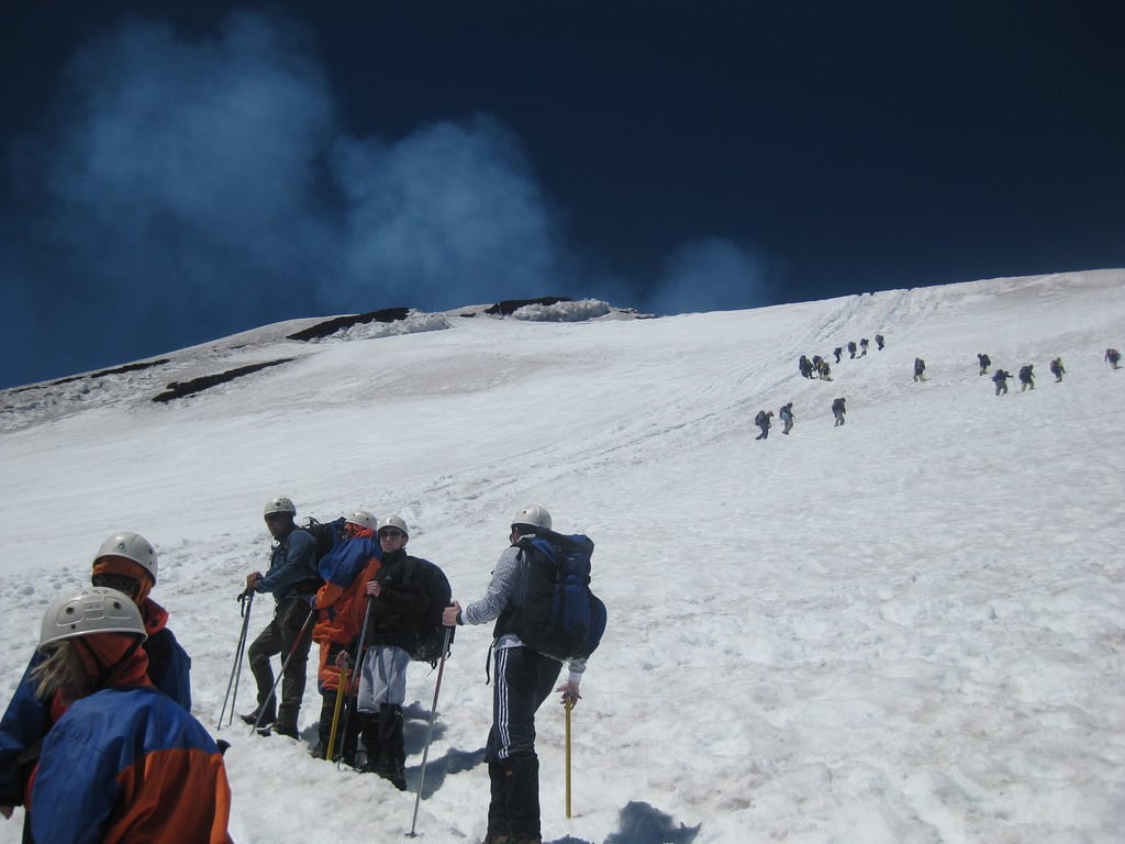 Tourists follow a guide up Villarica volcano near Pucon, Chile. 