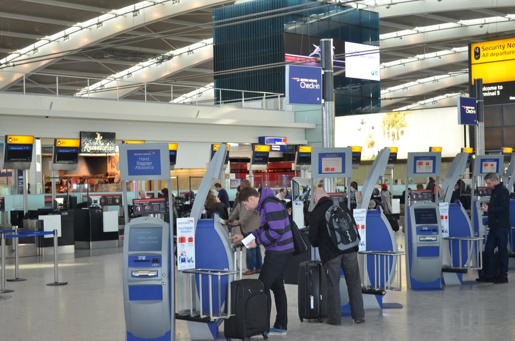 Passengers check in at Terminal 5 in Heathrow Airport.