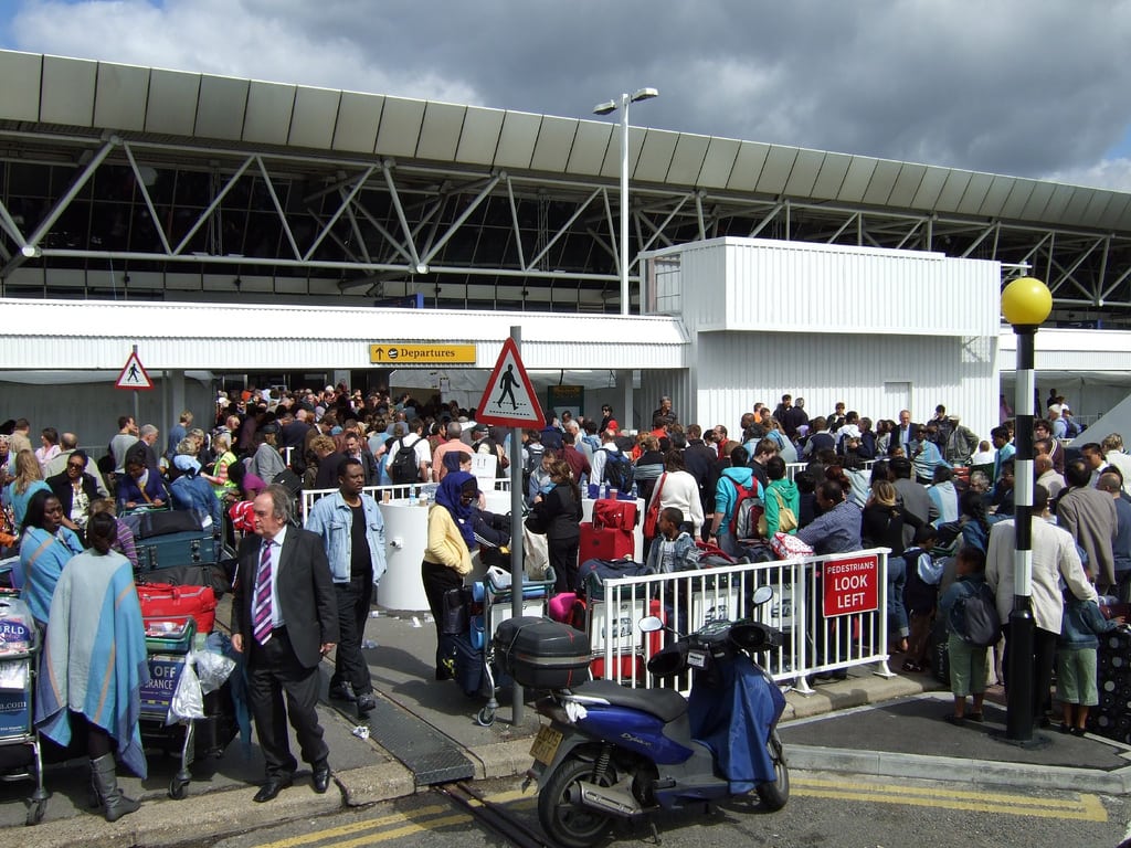 Massive lines form after delays at Heathrow Airport.