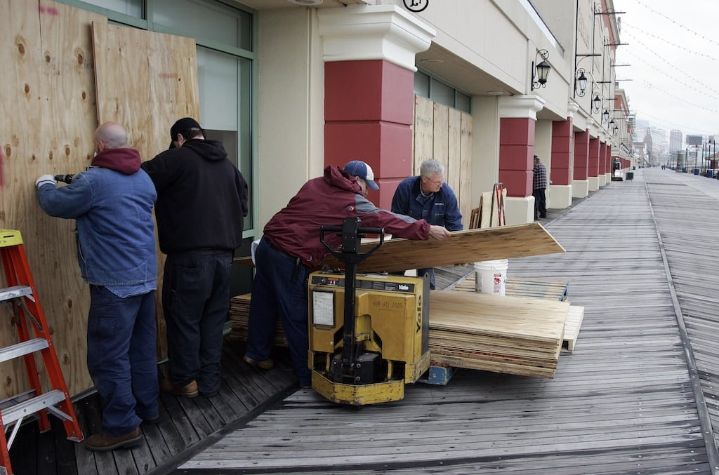 A crew from the Tropicana Casino removes plywood sheets from the windows facing the ocean on the boardwalk following the aftermath of Hurricane Sandy in Atlantic City, New Jersey, October 30, 2012. 