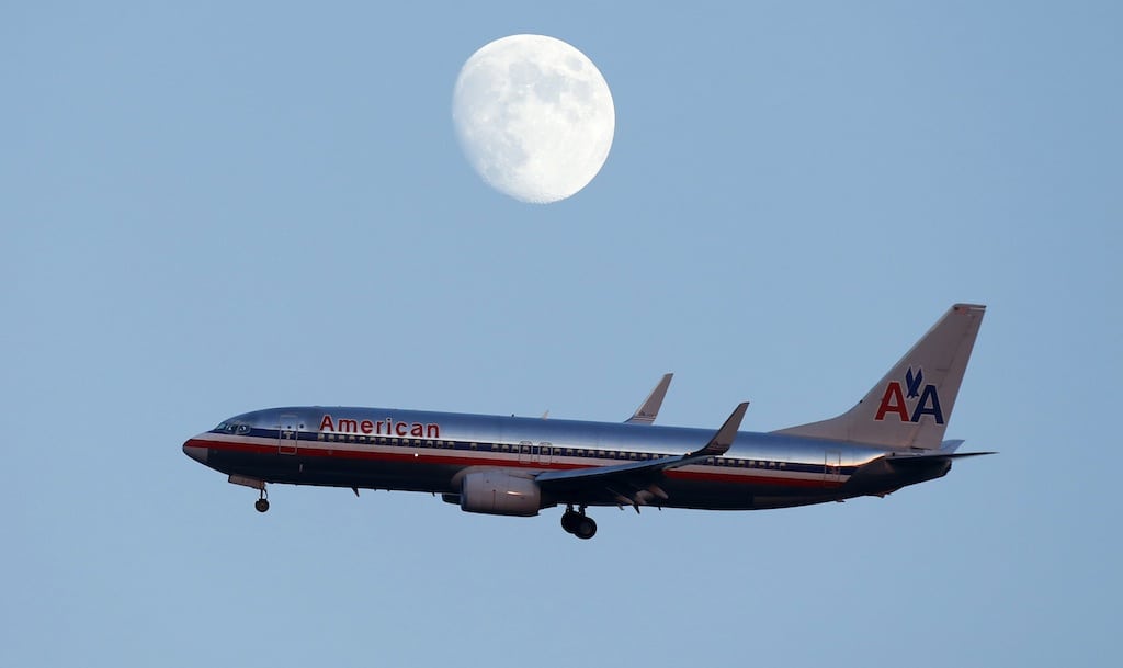 An American Airlines passenger jet glides in under the moon as it lands at LaGuardia airport in New YorkNew York, August 28, 2012. 