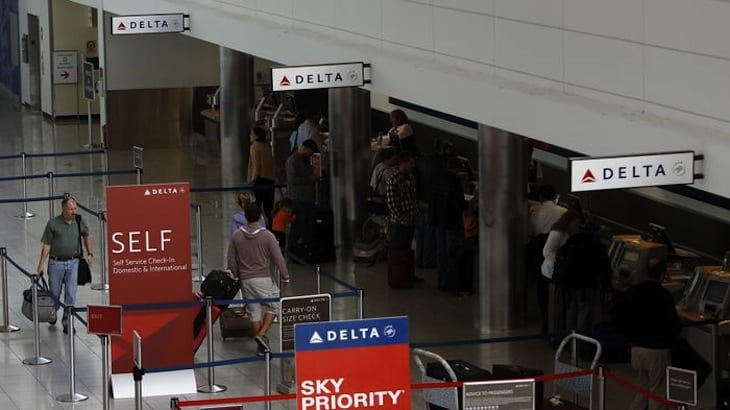 Delta Airlines passengers check in at BWI Thurgood Marshall International Airport near Baltimore, Maryland October 24, 2012.