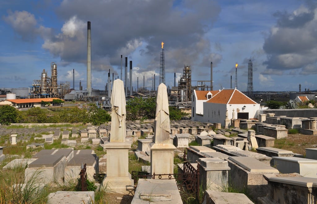 In this Nov. 12, 2012 photo, a portion of the Beth Haim cemetery, backdropped by the Isla oil refinery, is seen in Blenheim, on the outskirts of Willemstad, Curacao. 