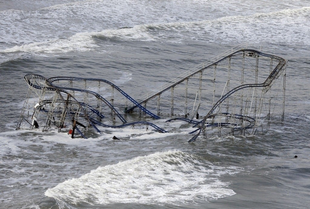 In this Wednesday, Oct. 31, 2012 file photo, waves wash over a roller coaster from a Seaside Heights, N.J., amusement park that fell in the Atlantic Ocean during Superstorm Sandy.
