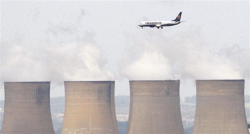 A Ryanair aircraft is seen flying above Ratcliffe Power Station as it comes into land at East Midlands Airport, central England in this July 1, 2008 file photograph.
