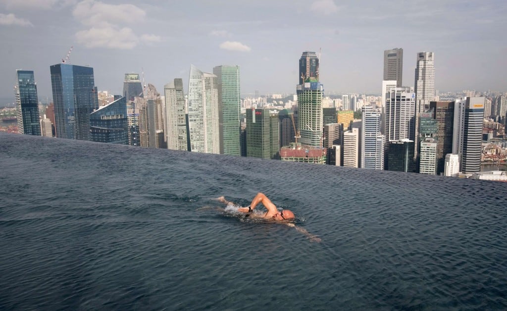 A guest swims in the infinity pool of the Skypark that tops the Marina Bay Sands hotel towers in Singapore in this June 24, 2010 file photo.