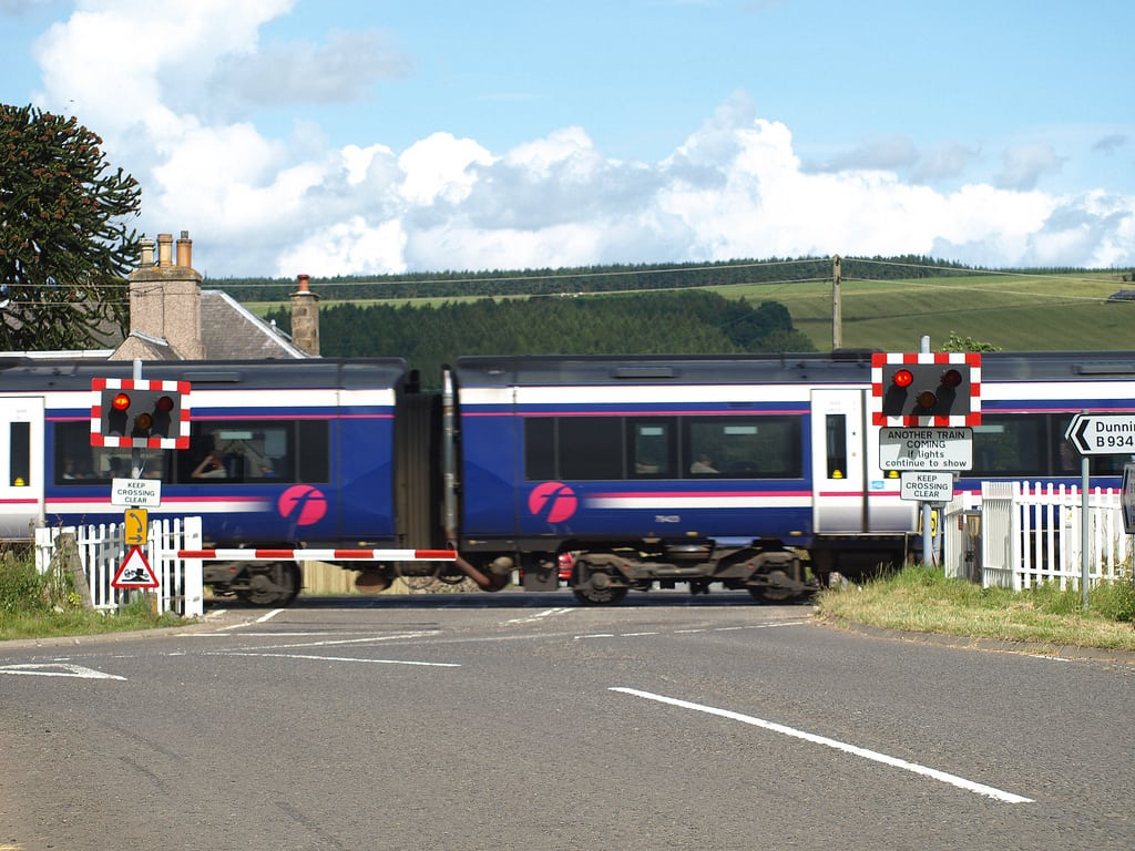 A Glasgow-bound Scotrail train on the crossing at Forteviot, Scotland. 