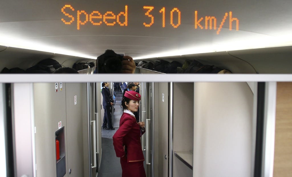 An attendant stands inside a high-speed train during an organized experience trip from Beijing to Zhengzhou, as part of a new rail line, December 22, 2012. 