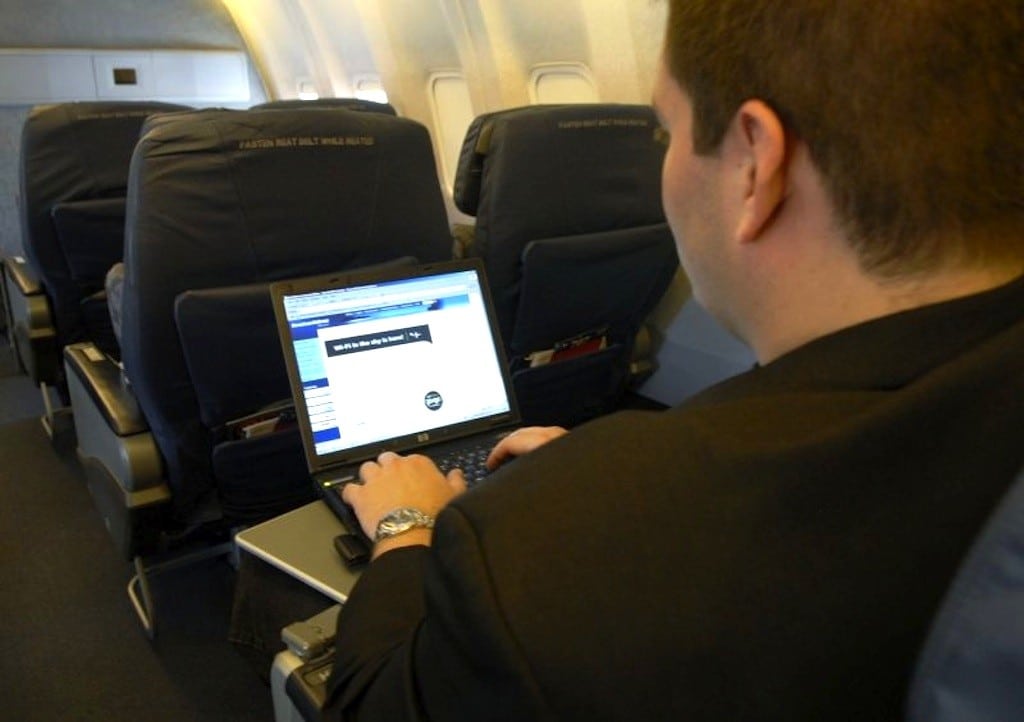 Passenger using Gogo inflight Internet on his laptop. 