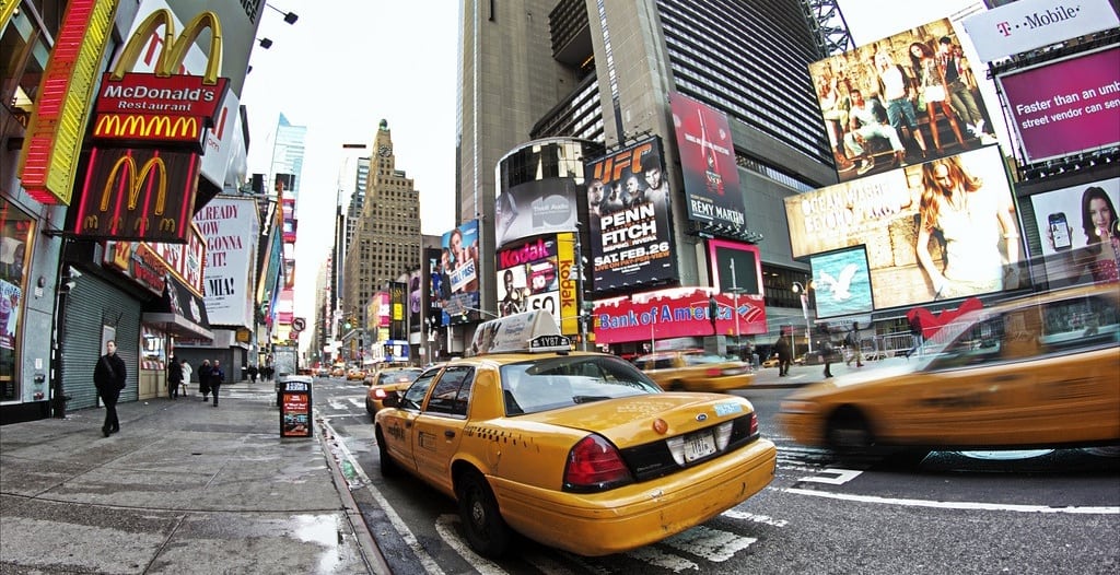 Taxis drive through Times Square. 