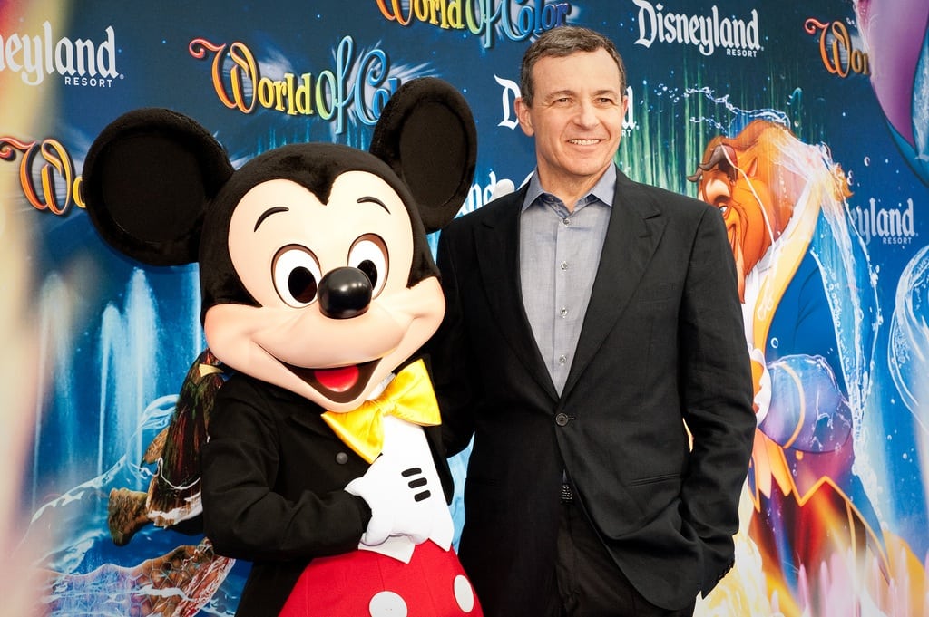 Walt Disney Co. chairman and CEO Bob Iger is shown at Disney California Adventure Park with Mickey Mouse. Iger told analysts he was "open" to staying in the job beyond his current contract. 