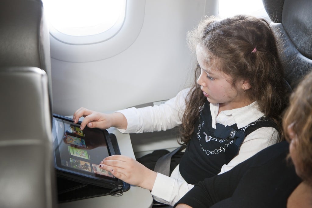 A child using an iPad from Jetstar Airways. 
