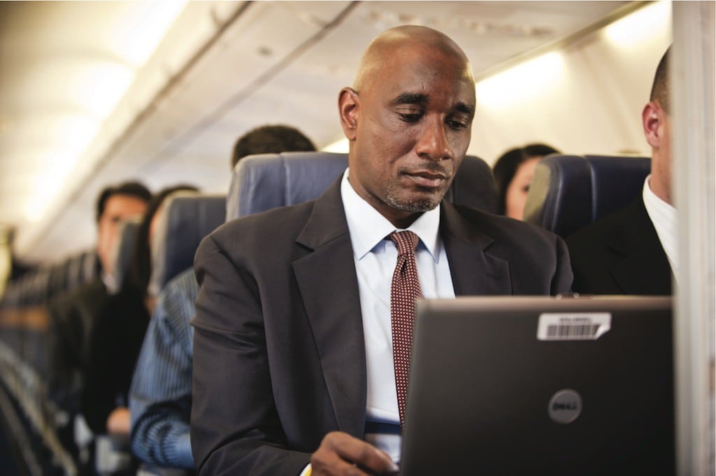 A man checks his email using in-flight Wi-Fi. 