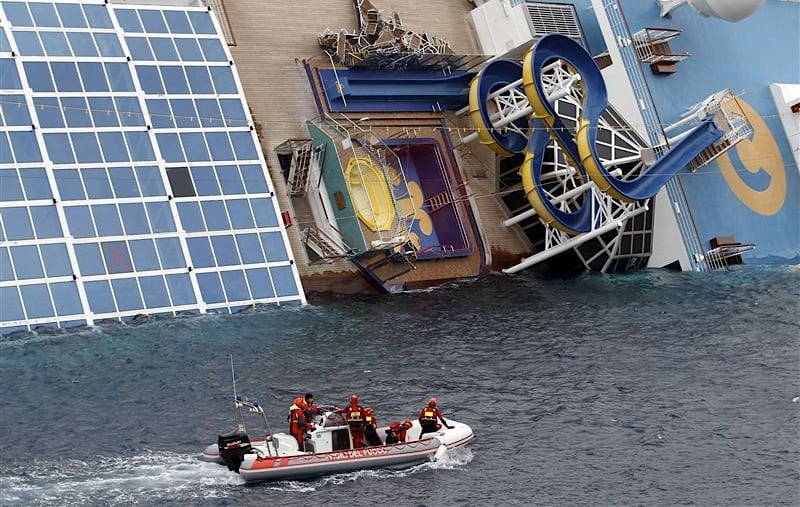 Rescue workers inspect the capsized Costa Concordia cruise ship that ran aground off the west coast of Italy at Giglio island January 16, 2012. 
