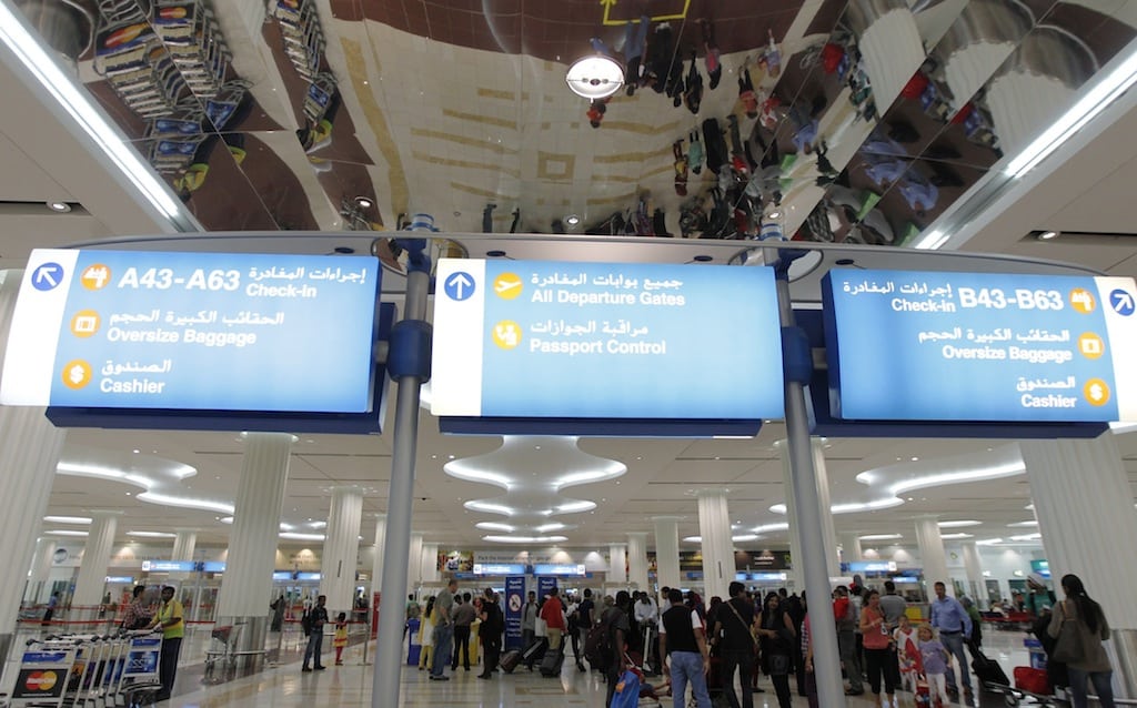 Travellers are seen at the Emirates terminal at Dubai International Airport, January 7, 2013. 