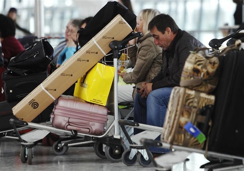  Passengers wait with their luggage at Heathrow airport in London during a previous delay March 16, 2012. 