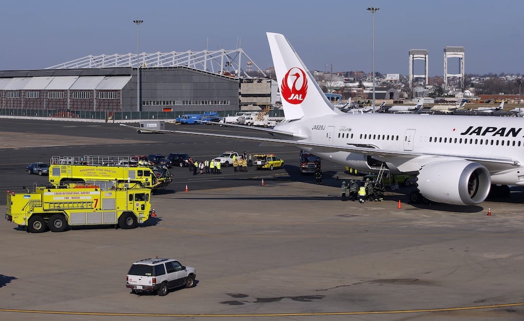 Fire trucks surround a Japan Airlines Boeing 787 Dreamliner that caught fire at Logan International Airport in Boston, Massachusetts January 7, 2013. The parked Boeing Co 787 Dreamliner aircraft with no passengers on board caught fire at Boston's Logan International Airport while parked at a gate on Monday morning, an airport spokesman said. 