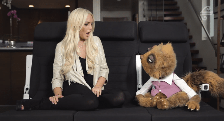 Lindsay Lohan and Air New Zealand's pervy puppet Rico on a Skycouch. 