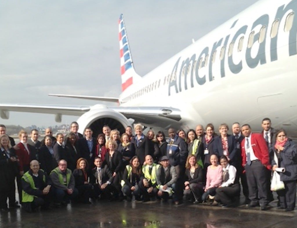 American Airlines employees at LaGuardia Airport examing the airline's then-new livery.
