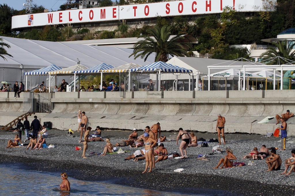 Bathers are seen on the rock-strewn beach on the Black Sea at the coastal resort of Sochi, Russia. 