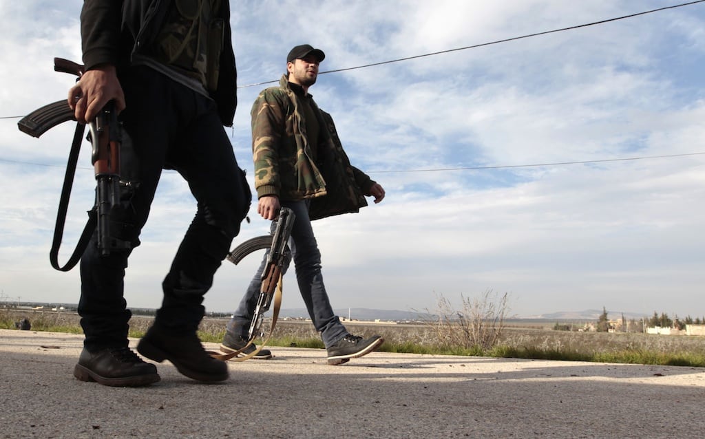 Free Syrian Army fighters walk as they seize Menagh military airport in north Aleppo December 28, 2012. 
