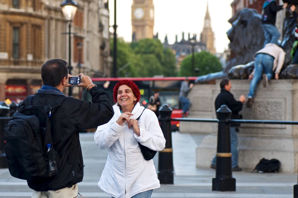 Tourists at Trafalgar Square in London. 