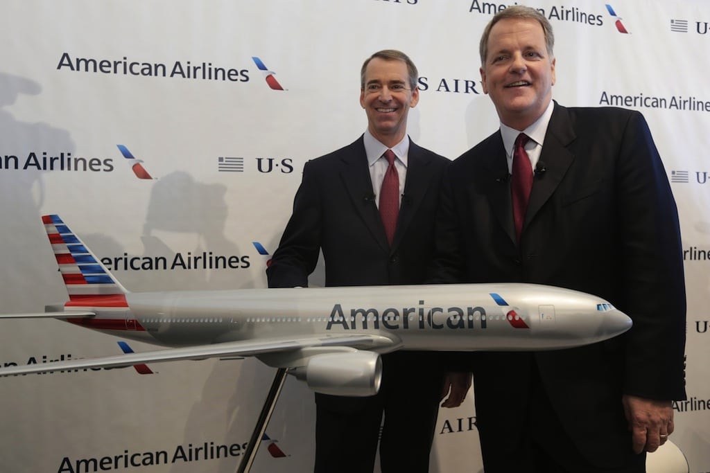 In this Feb. 14, 2013 file photo, U.S. Airways CEO Doug Parker, right, and American Airlines CEO Tom Horton pose after a news conference at DFW International Airport.
