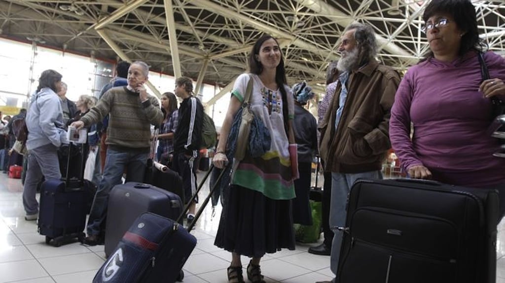 Cuban dissident blogger Yoani Sanchez waits in line to have her documents checked at passport control before leaving Cuba to travel to Brazil and other countries at the Jose Marti International Airport in Havana, Cuba, Sunday, Feb. 17, 2013.