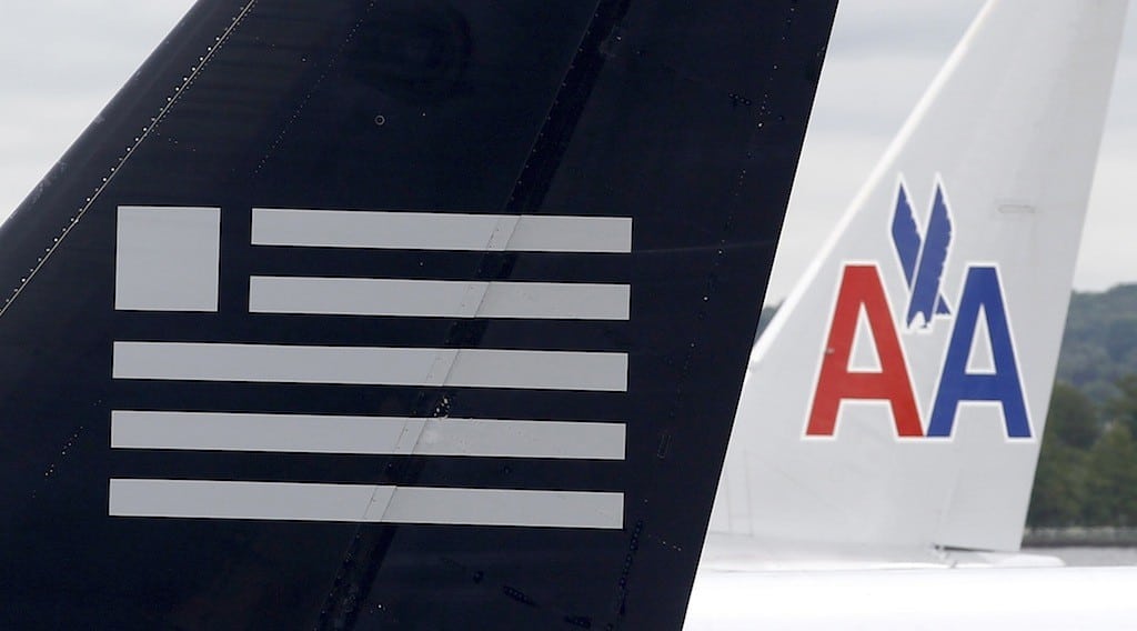 A US Airways plane and an American Airlines plane share a terminal at Ronald Reagan National Airport in Washington April 23, 2012. 
