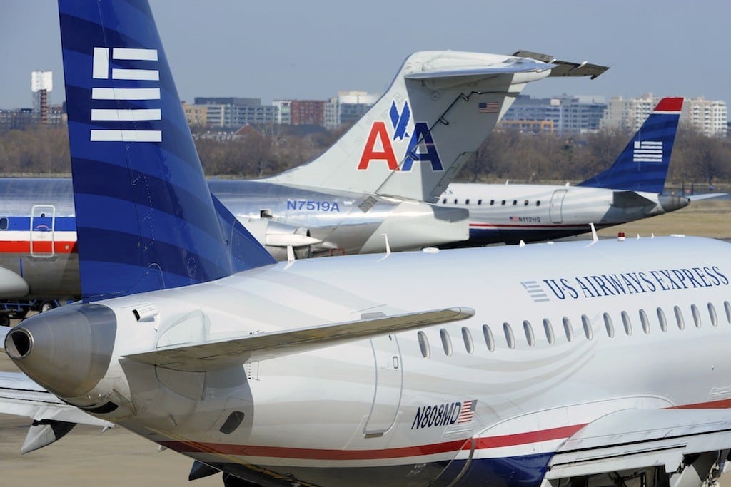 An American Airlines plane is seen between two US Airways Express planes at the Ronald Reagan Washington National Airport in Arlington County, Virginia, February 10, 2013.
