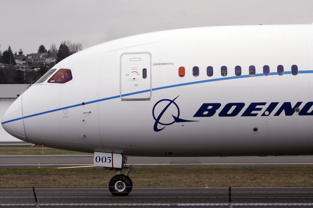 A pilot waves to bystanders while taxiing after landing a Boeing 787 Dreamliner following a flight test February 11, 2013, at Boeing Field in Seattle.  