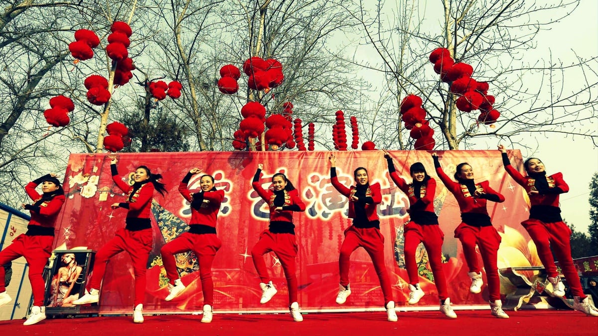 Dancers perform to "Gangnam Style" during the temple fair in Ditan Park, also known as the Temple of Earth, in Beijing February 9, 2013. 