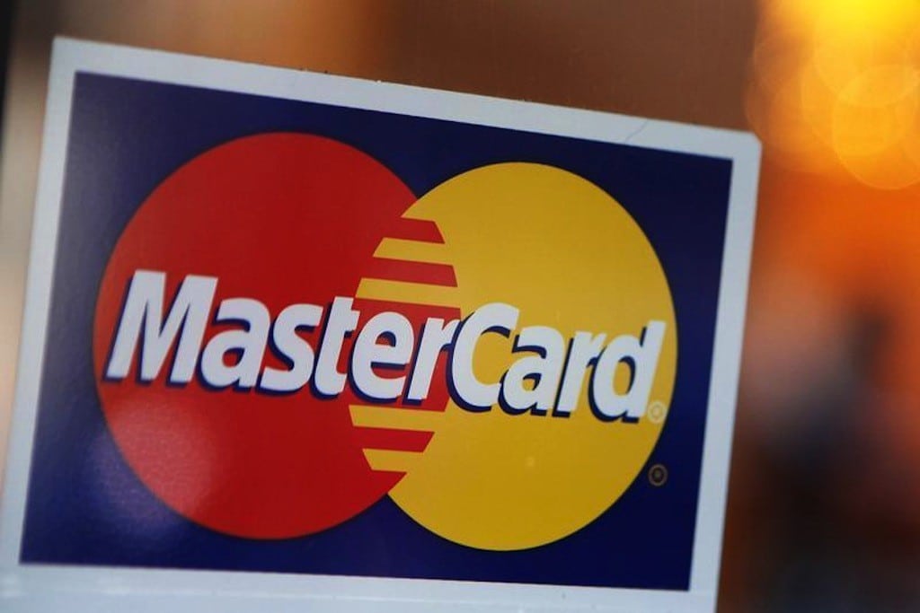 A MasterCard logo is seen on a door outside a restaurant in New York, February 3, 2010. 