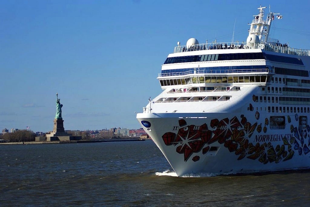 Another Norwegian cruise ship sails past the iconic Statue of Liberty. 