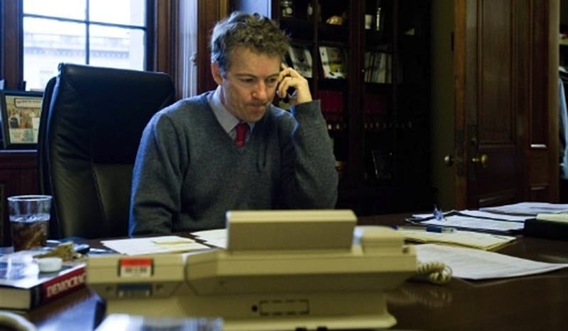 U.S. Senator Rand Paul (R-KY) at a desk in his office on Capitol Hill in Washington, January 23, 2012. The day before Paul was stopped at an airport and delayed multiple passengers while he refused a secondary screening. 