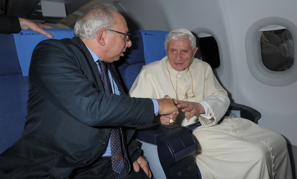 Rome Bureau Chief Victor Simpson, left, shakes hands with Pope Benedict XVI during the flight from Beirut to Rome, Sept. 16, 2012. 