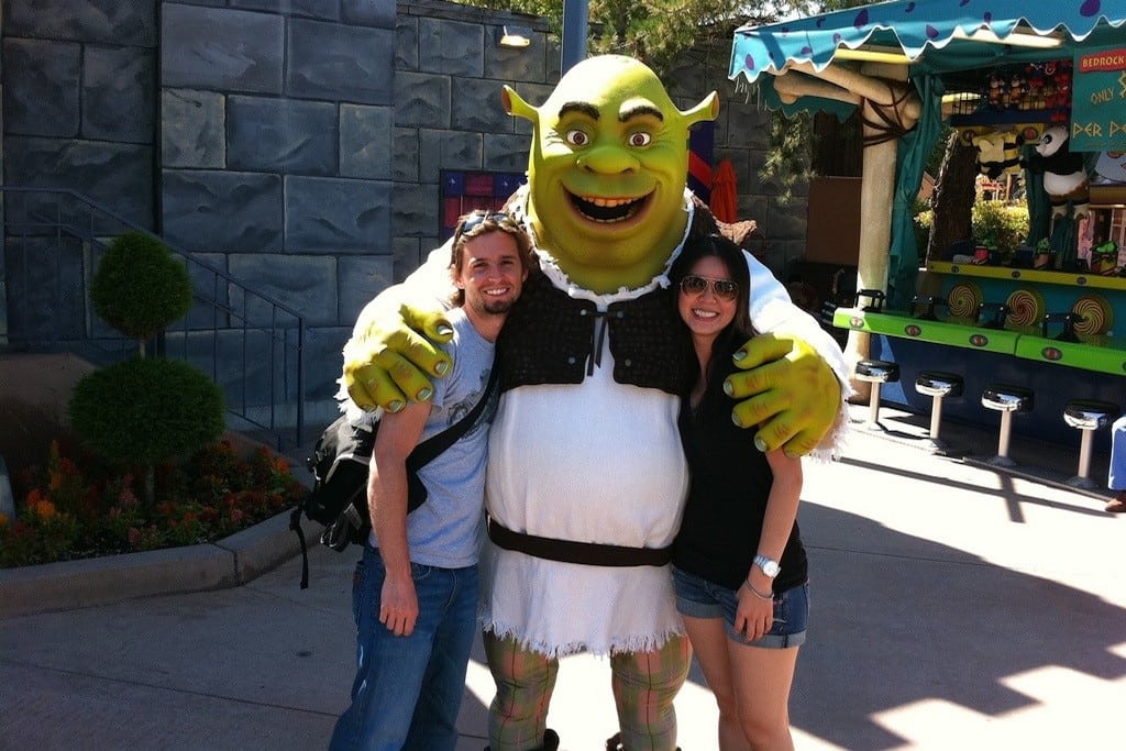 Tourists pose with Shrek at Universal Studios theme park. 