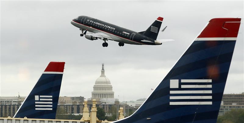 A US Airways Express plane takes off with the U.S. Capitol in the background at Ronald Reagan National Airport in Washington April 23, 2012. 