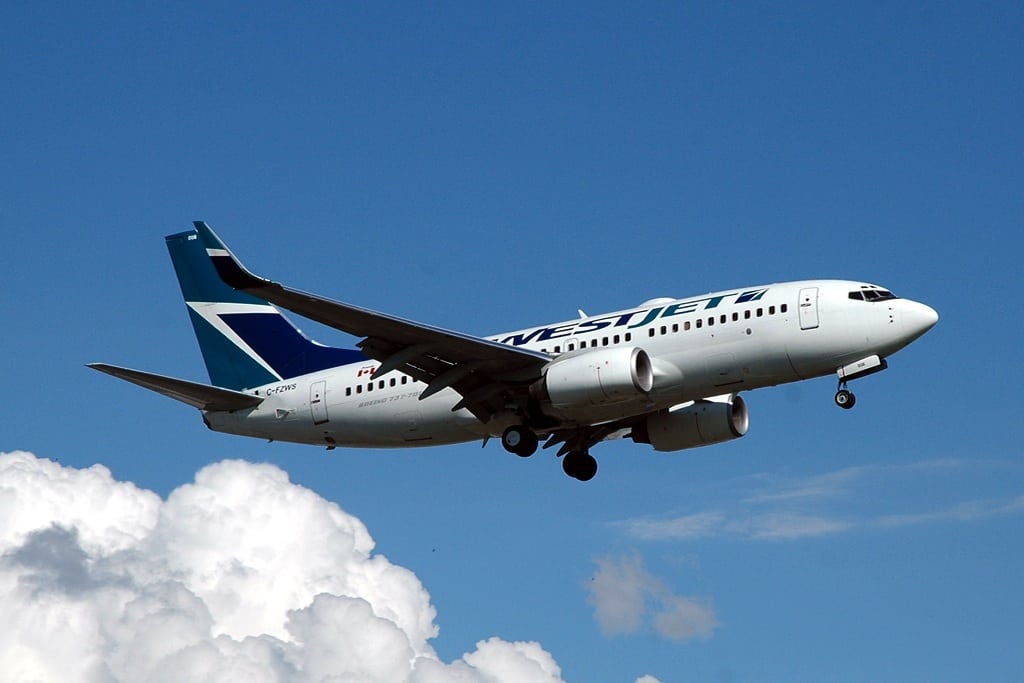 A Westjet Boeing 737 flying overhead as it approaches runway 24R in Montreal. 