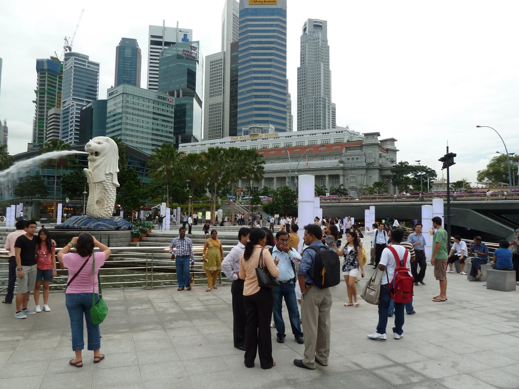 Tourists oohing and aahing over the Merlion sculpture in Singapore. 
