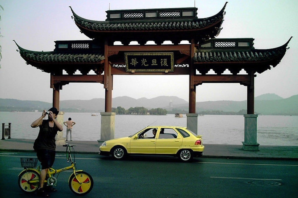 A man stops on his bicycle to take a photo in Hangzhou, China. 