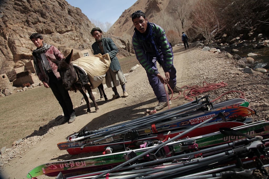 Goat-herder turned ski guide Sayed Ali Shah, 17, prepares to load a donkey with an assortment of cross-country skis and poles, so tourists can trek above the snow-line in Afghanistan's central highlands. 