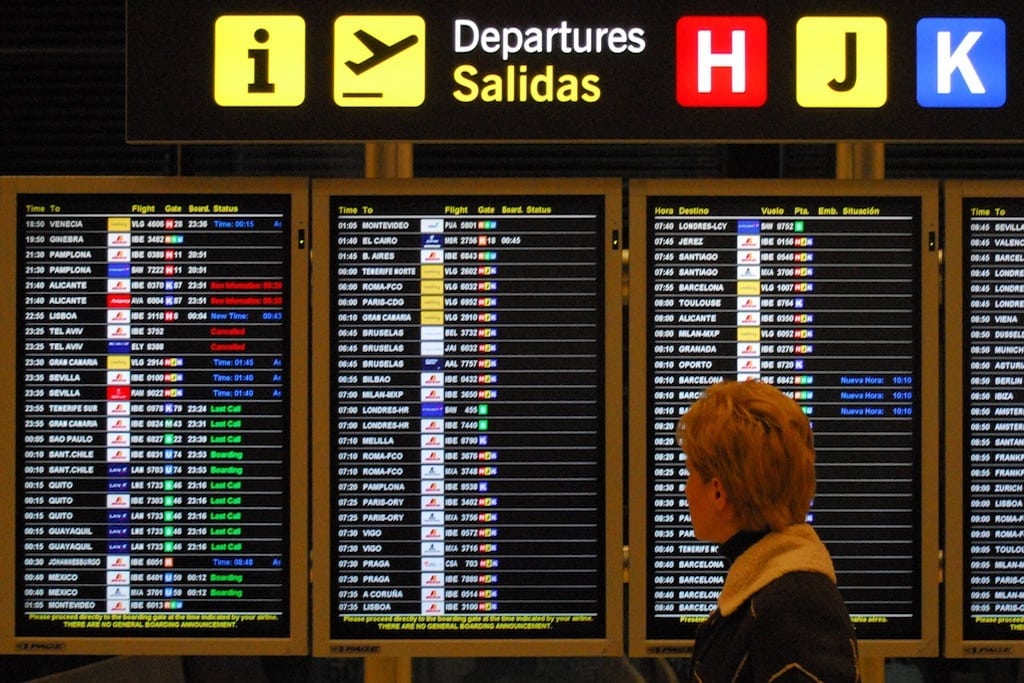A flyer looks for her return flight home in Madrid Barajas Airport, Spain. 