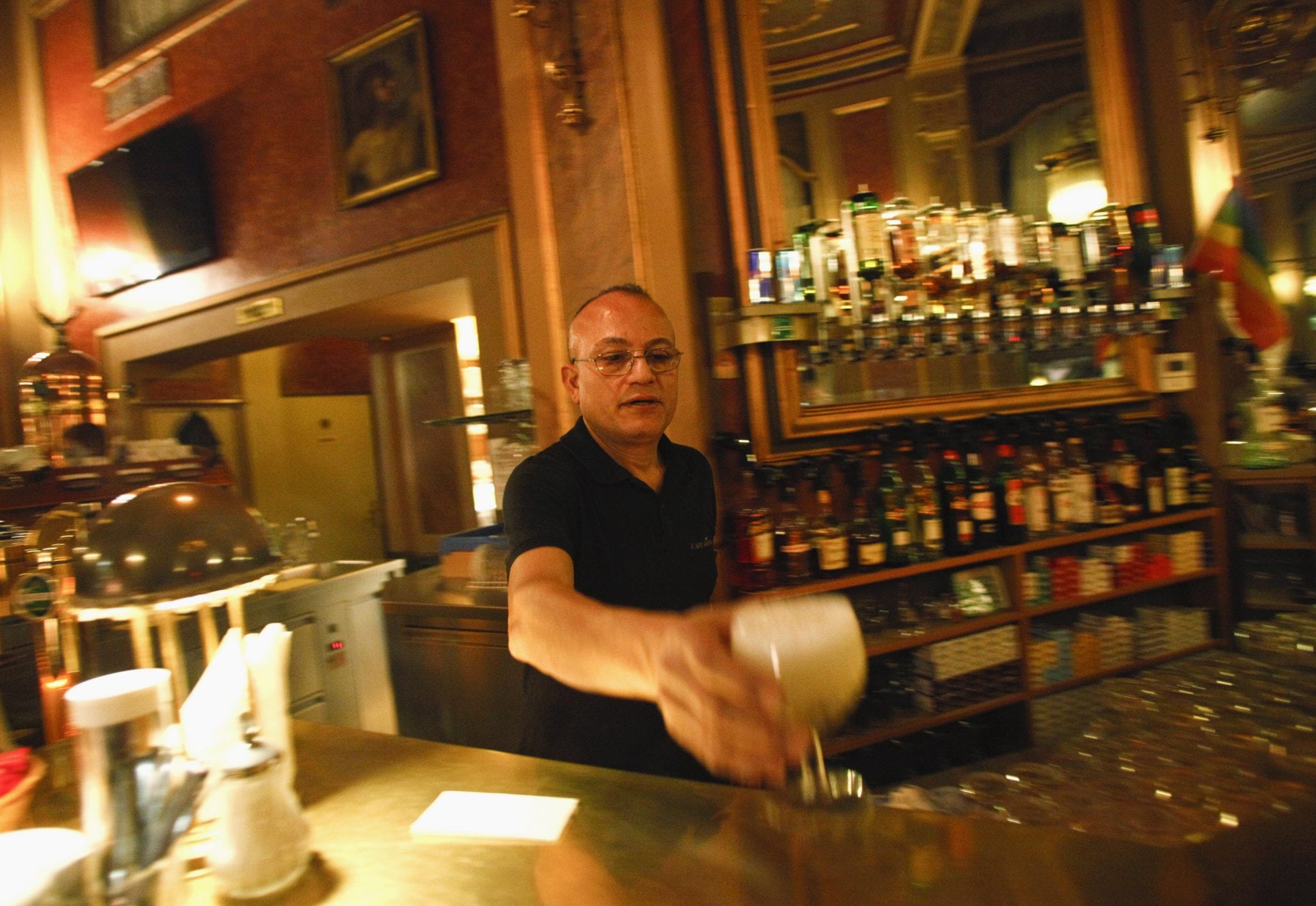 A waiter serves a drink at Cafe Savoy, which caters to lesbian, gay, bisexual and transgender customers in Vienna.  