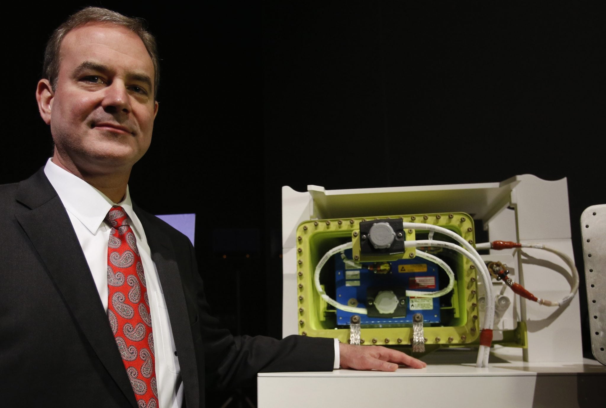Boeing vice president and 787 Dreamliner chief production engineer Sinnett poses with model of Boeing's 787 Battery Design. 